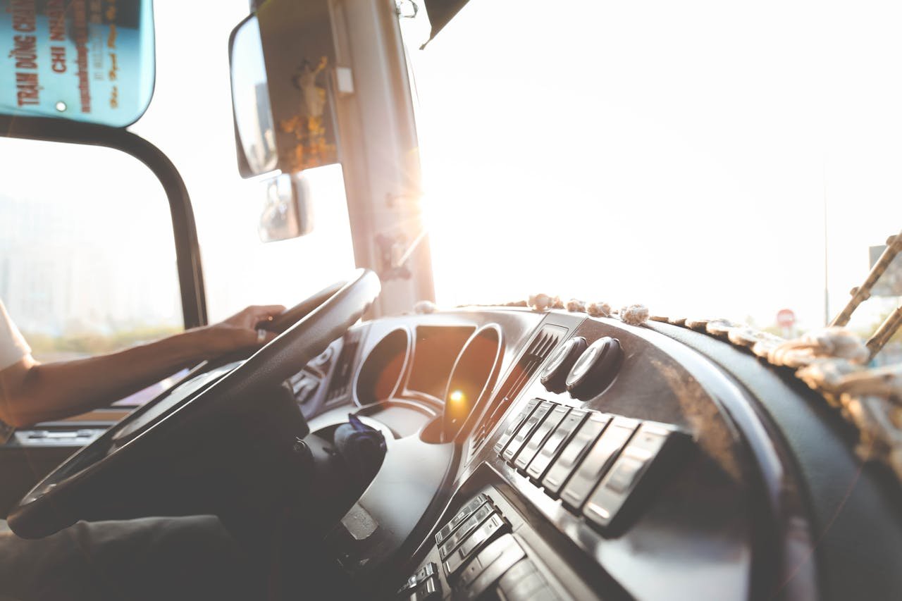 Truck driver in cab monitoring freight rates and routes